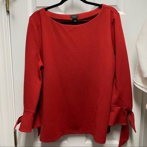 Burnt orange top with bows on sleeve